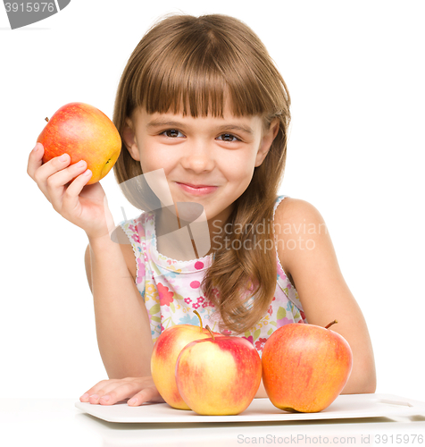 Image of Little girl with red apples