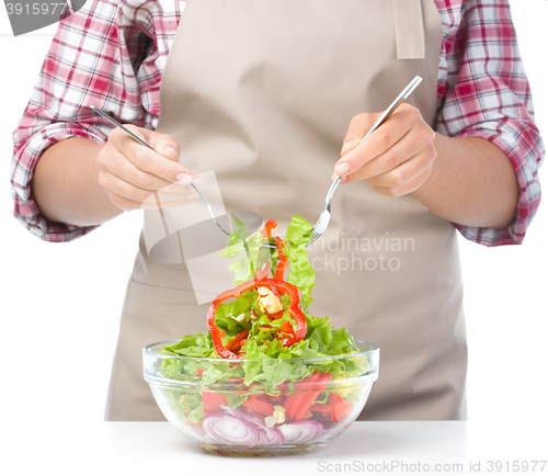 Image of Cook is mixing salad