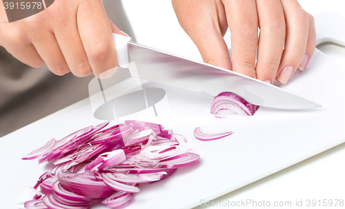 Image of Cook is chopping onion