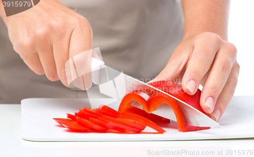 Image of Cook is chopping bell pepper