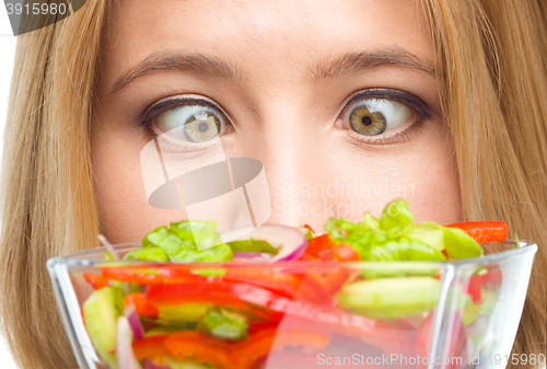 Image of Woman is looking at salad