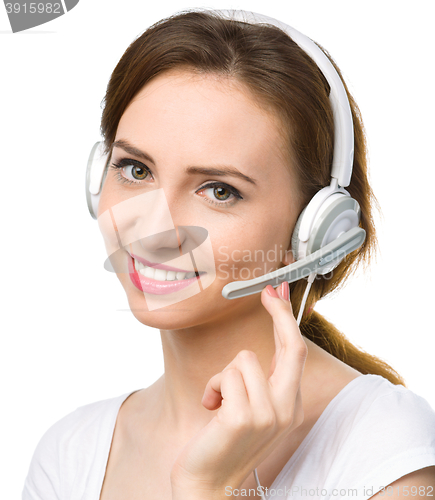 Image of Lovely young woman is talking to customers