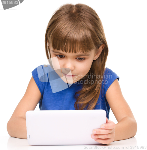 Image of Young girl is using tablet
