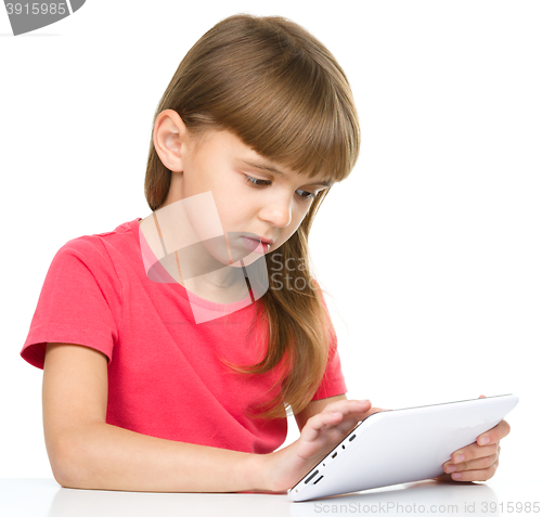 Image of Young girl is using tablet