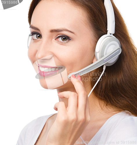 Image of Lovely young woman is talking to customers