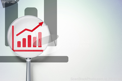Image of Advertising concept:  Growth Graph with optical glass on digital background