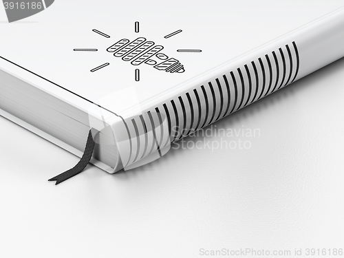 Image of Business concept: closed book, Energy Saving Lamp on white background