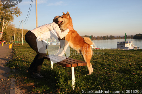 Image of Lady cuddling with her dog