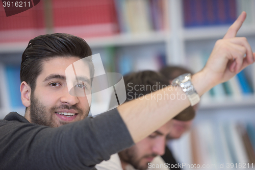 Image of group of students  raise hands up