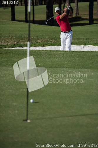 Image of golfer hitting a sand bunker shot