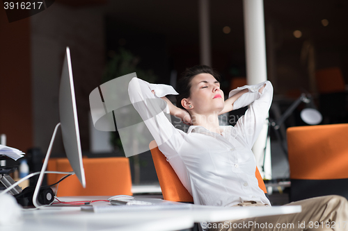 Image of happy young business woman relaxing and geting insiration