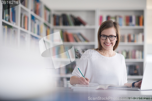 Image of female student study in school library