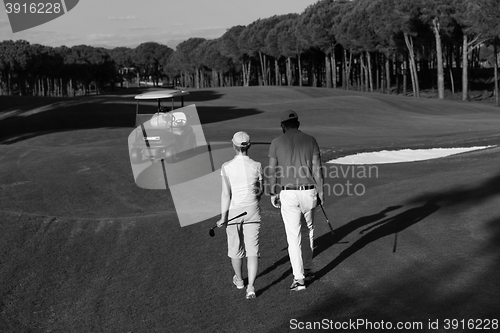 Image of couple walking on golf course