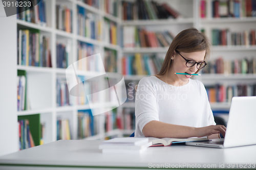 Image of female student study in school library