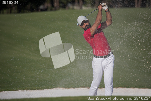 Image of golfer hitting a sand bunker shot