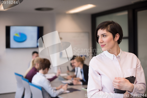 Image of hispanic businesswoman with tablet at meeting room