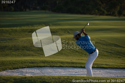 Image of golfer hitting a sand bunker shot on sunset