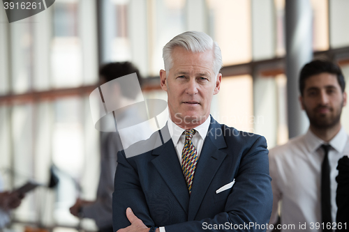 Image of portrait of handsome senior business man at modern office