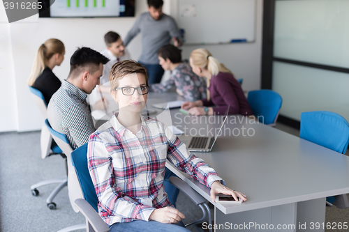Image of portrait of young business woman at office with team on meeting 
