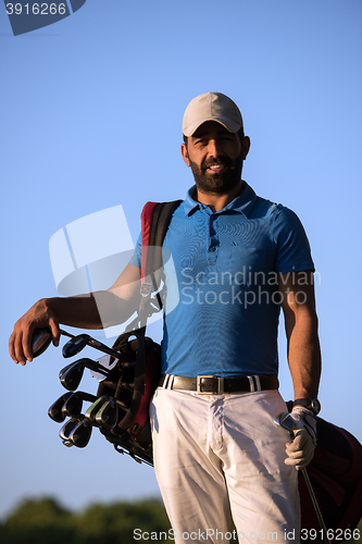 Image of golfer  portrait at golf course on sunset