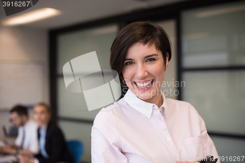 Image of hispanic businesswoman with tablet at meeting room