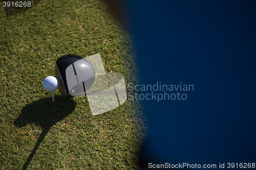 Image of top view of golf club and ball in grass