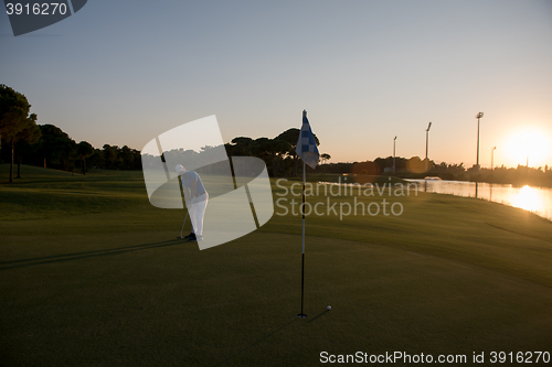 Image of golfer hitting ball to hole