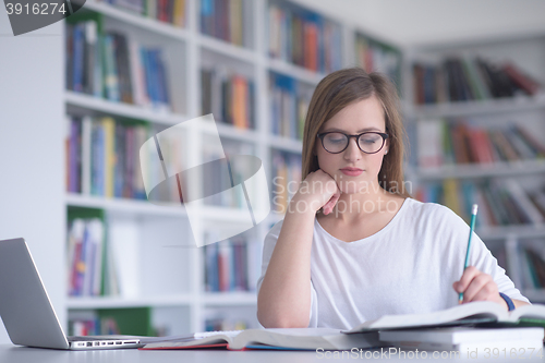 Image of female student study in school library