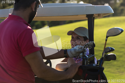 Image of couple in buggy on golf course