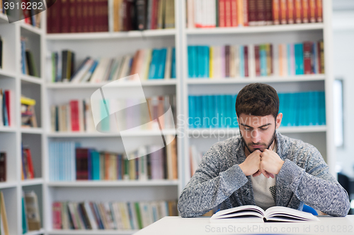 Image of portrait of student while reading book  in school library