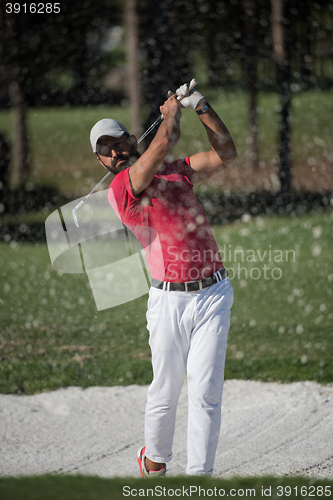 Image of golfer hitting a sand bunker shot