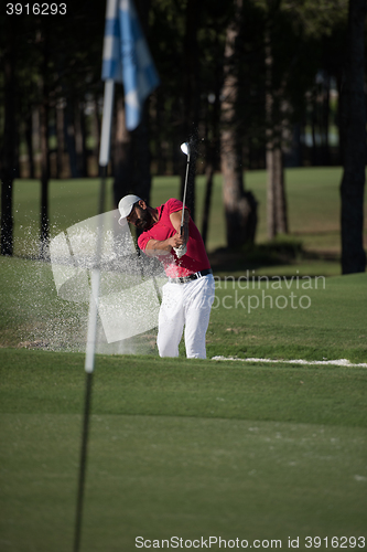 Image of golfer hitting a sand bunker shot