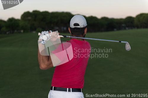 Image of golfer hitting a sand bunker shot on sunset