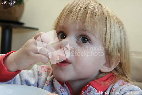Image of Young girl eating