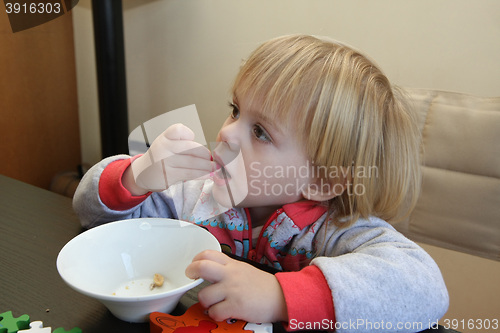 Image of Young girl eating