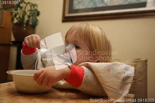 Image of Young girl eating