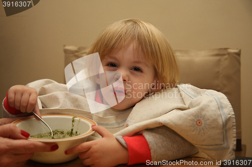 Image of Young girl eating