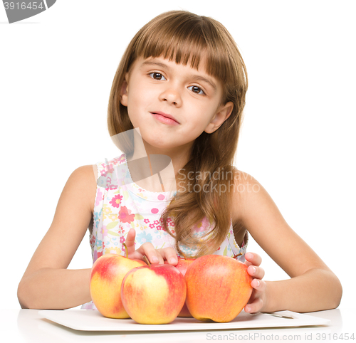 Image of Little girl with red apples