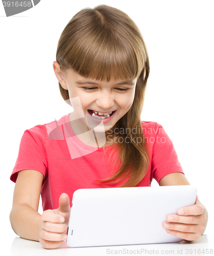 Image of Young girl is using tablet