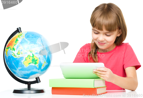 Image of Young girl is using tablet