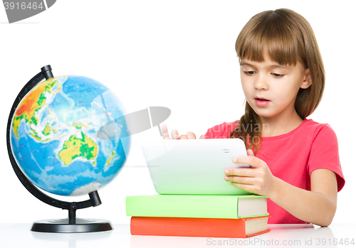 Image of Young girl is using tablet