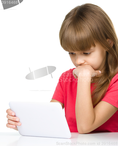 Image of Young girl is using tablet while studying