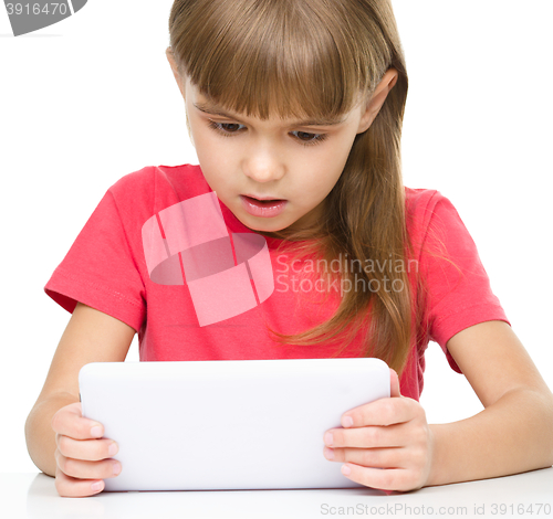 Image of Young girl is using tablet