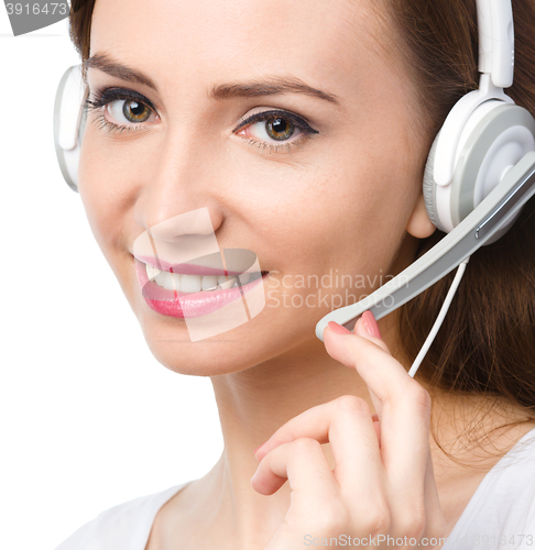 Image of Lovely young woman is talking to customers