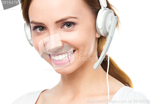 Image of Lovely young woman is talking to customers