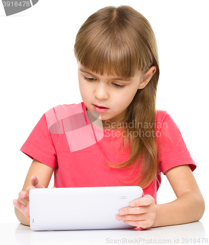 Image of Young girl is using tablet