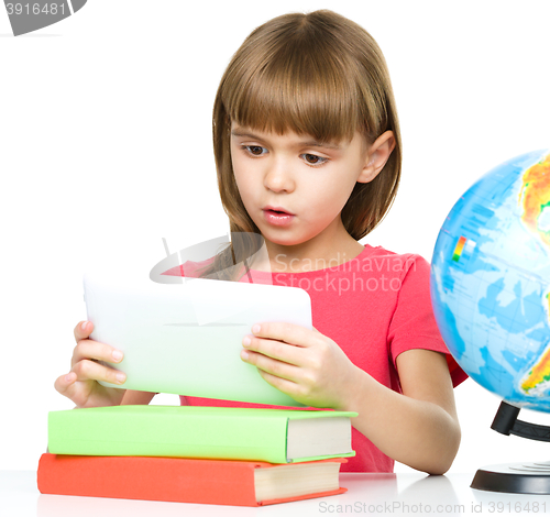 Image of Young girl is using tablet