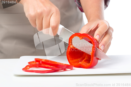 Image of Cook is chopping bell pepper