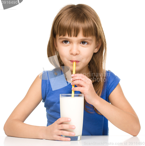 Image of Cute little girl with a glass of milk