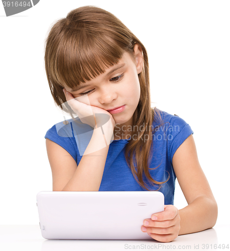 Image of Young girl is using tablet